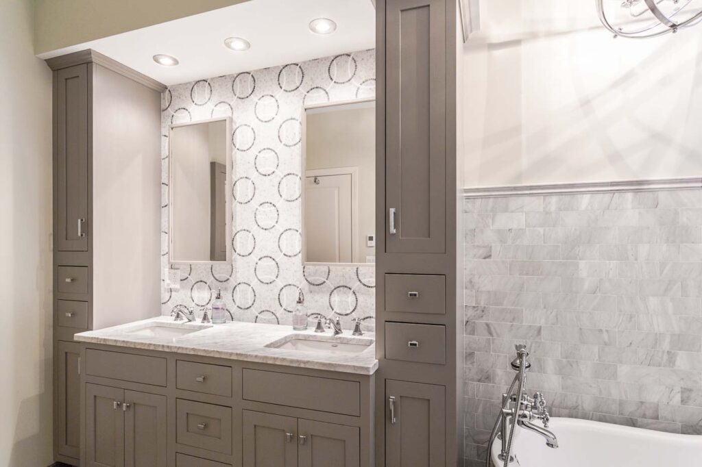 Carrara marble tops with polished nickel faucets